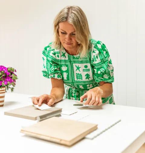 Sara Cornish reviewing material samples at a kitchen bench